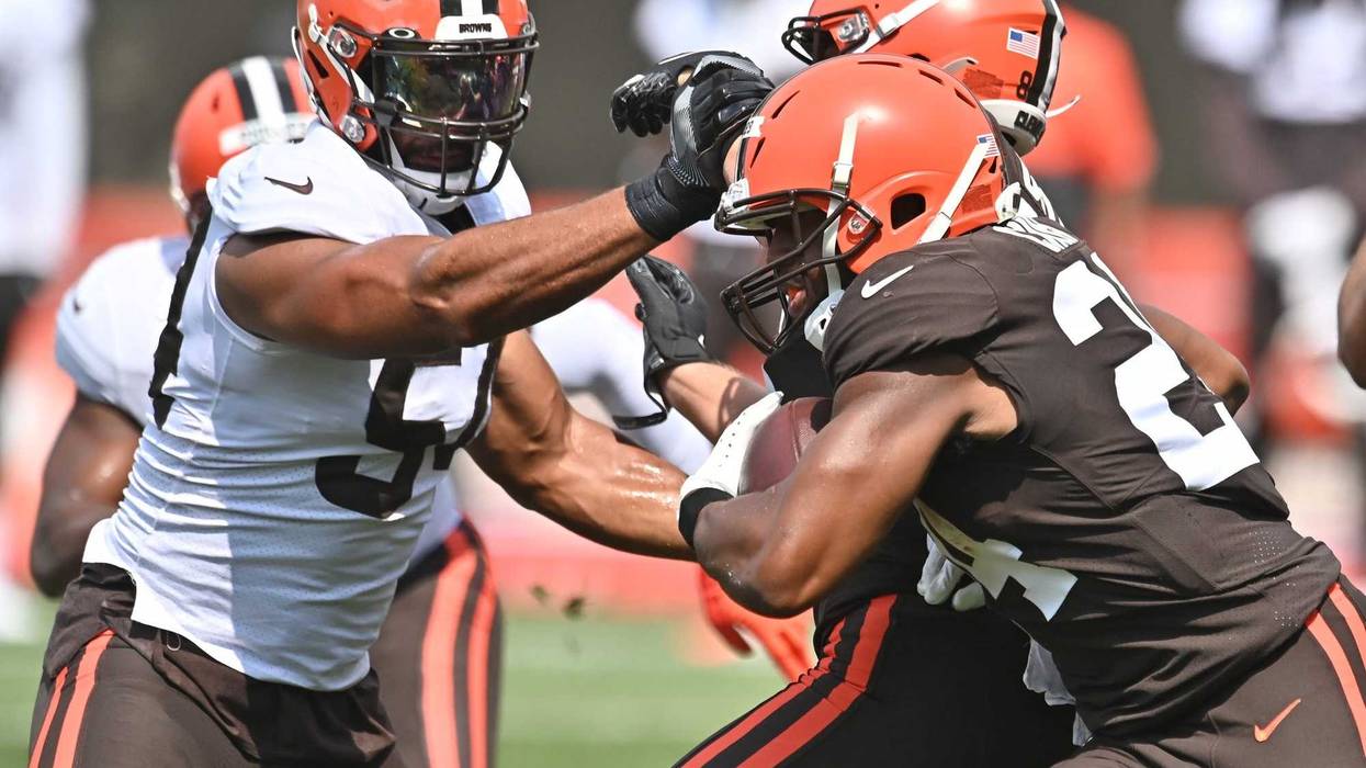 Cleveland Browns running back Nick Chubb runs with the ball as tight end Harrison Bryant blocks defensive end Olivier Vernon during training camp at the Cleveland Browns training facility.