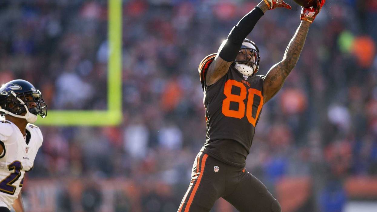 Cleveland Browns wide receiver Jarvis Landry (80) leaps for the ball past Baltimore Ravens cornerback Marcus Peters (24) during the second quarter at FirstEnergy Stadium.