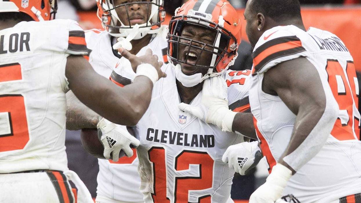 Cleveland Browns wide receiver Josh Gordon (12) celebrates with quarterback Tyrod Taylor (5) and defensive tackle Devaroe Lawrence (99) after catching a touchdown during the fourth quarter at FirstEnergy Stadium.