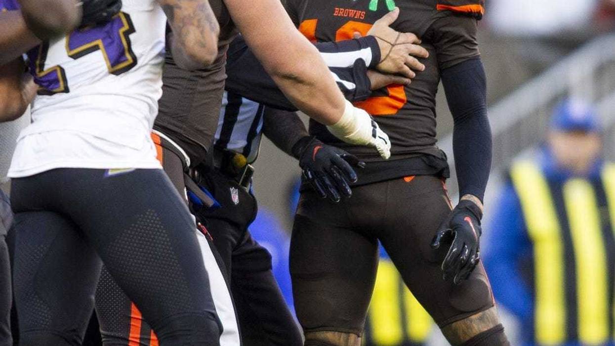 Cleveland Browns wide receiver Odell Beckham (13) is held back as he exchanges words with Baltimore Ravens cornerback Marcus Peters (24) during the fourth quarter at FirstEnergy Stadium.
