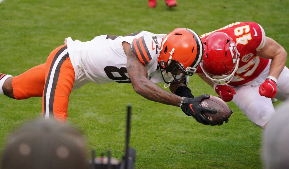Cleveland Browns wide receiver Rashard Higgins (82) moves the ball on a scoring attempt against Kansas City Chiefs free safety Daniel Sorensen (49) during the first half in the AFC Divisional Round playoff game at Arrowhead Stadium.