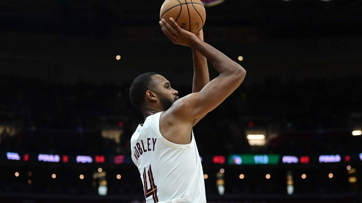 Cleveland Cavaliers forward Evan Mobley (4) shoots a three point basket during the second half against the Philadelphia 76ers at Rocket Mortgage FieldHouse.