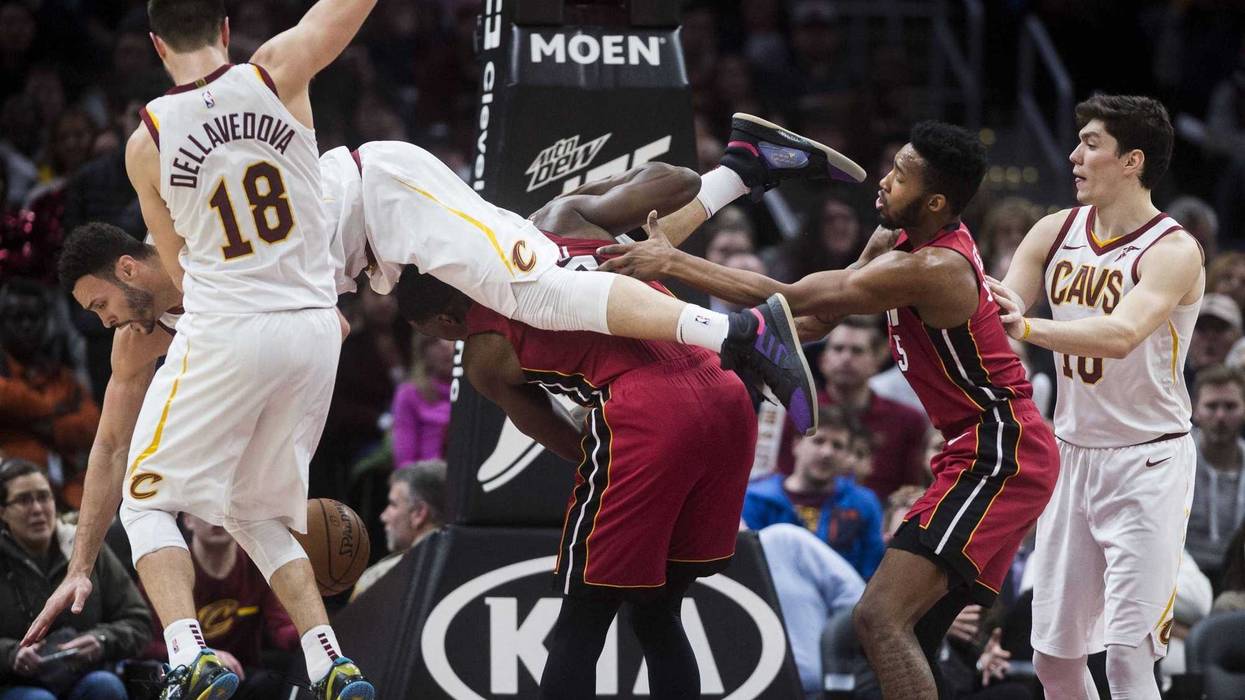Cleveland Cavaliers forward Larry Nance Jr. (22) comes down on top of Miami Heat center Bam Adebayo (13) during the second half at Quicken Loans Arena.