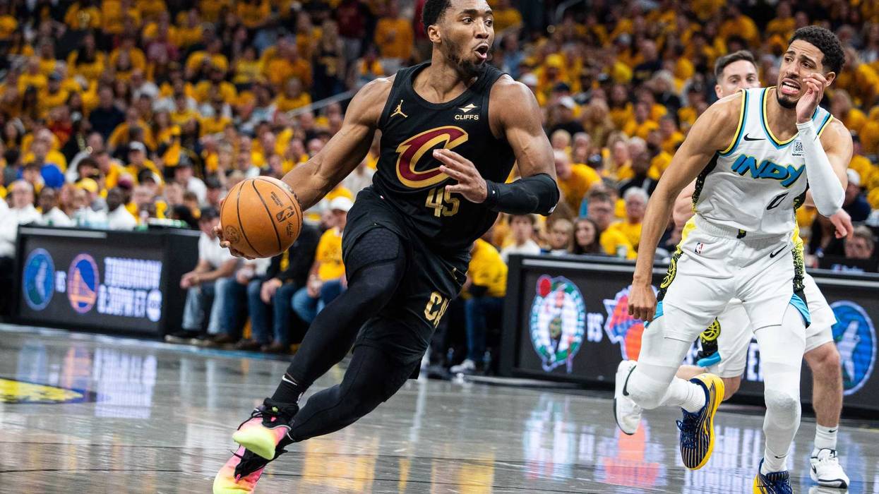 Cleveland Cavaliers guard Donovan Mitchell (45) dribbles the ball while Indiana Pacers guard Tyrese Haliburton (0) defends during game three of the second round for the 2025 NBA Playoffs at Gainbridge Fieldhouse.