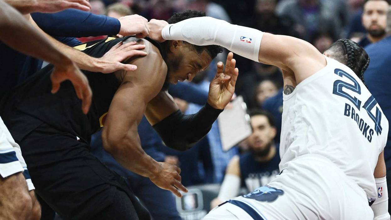 Cleveland Cavaliers guard Donovan Mitchell (45) fights with Memphis Grizzlies forward Dillon Brooks (24)