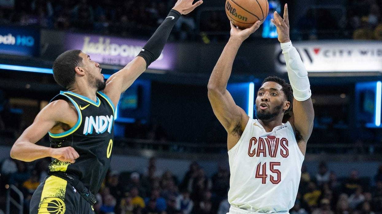 Cleveland Cavaliers guard Donovan Mitchell (45) shoots while Indiana Pacers guard Tyrese Haliburton (0) defends at Gainbridge Fieldhouse.