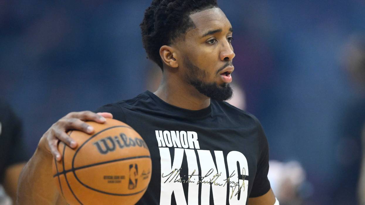 Cleveland Cavaliers guard Donovan Mitchell (45) warms up wearing a Martin Luther King Jr. shirt before a game against the Chicago Bulls at Rocket Mortgage FieldHouse.
