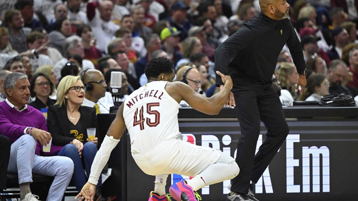 Cleveland Cavaliers head coach J. B. Bickerstaff helps guard Donovan Mitchell (45) to his feet in the second quarter against the Orlando Magic during game two of the first round of the 2024 NBA playoffs at Rocket Mortgage FieldHouse.