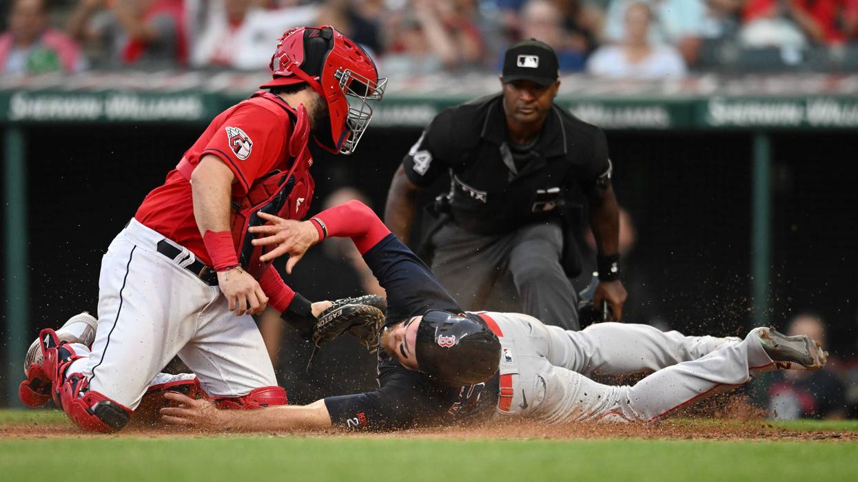Cleveland Guardians catcher Austin Hedges (17) tags out Boston Red Sox shortstop Christian Arroyo (39) during the fifth inning at Progressive Field.