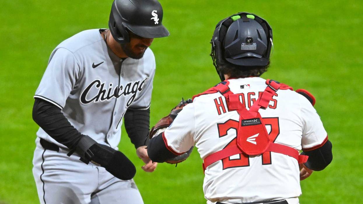 Cleveland Guardians catcher Austin Hedges (27) tags out Chicago White Sox right fielder Mike Tauchman (18) for the final out of the game in the ninth inning at Progressive Field.