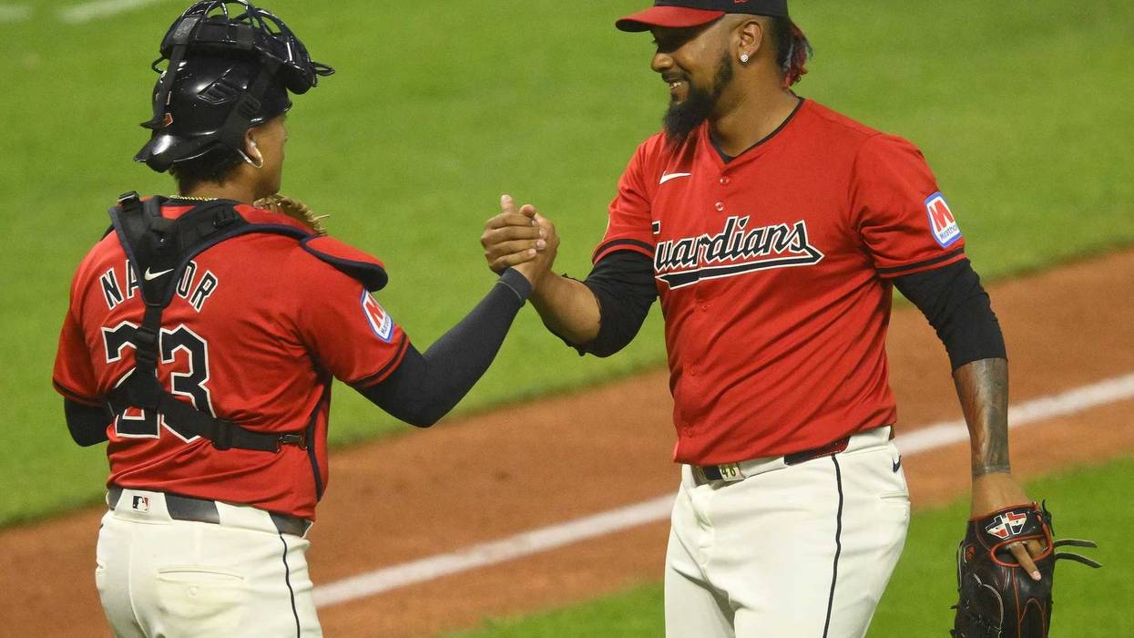 Cleveland Guardians catcher Bo Naylor (23) and relief pitcher Emmanuel Clase (48) celebrate a win over the Cincinnati Reds at Progressive Field.