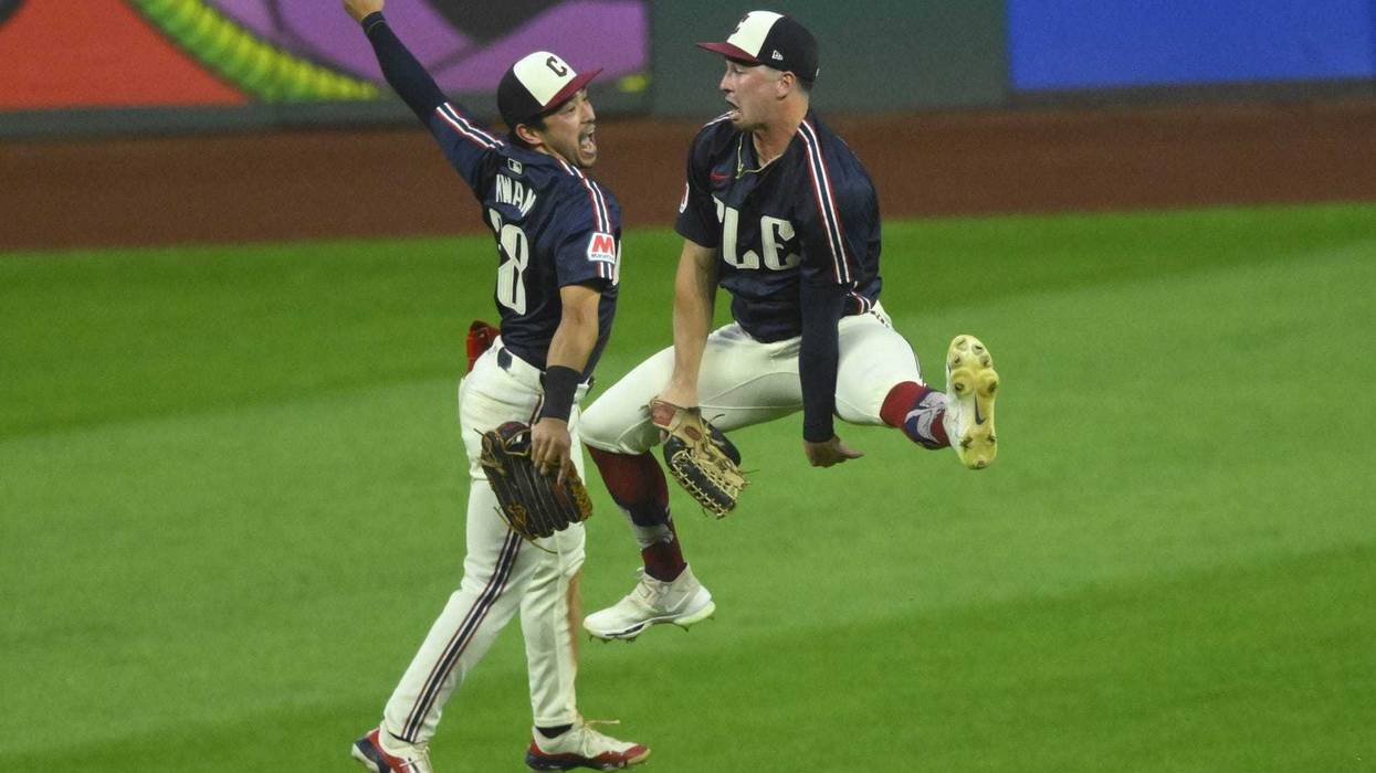 Cleveland Guardians left fielder Steven Kwan (38) and right fielder Will Brennan (17) celebrate a win over the Kansas City Royals at Progressive Field.
