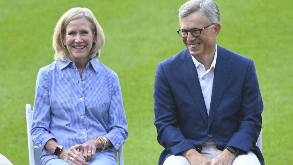 Cleveland Guardians owners Karen Dolan and Paul Dolan sit on the field before a game against the Detroit Tigers at Progressive Field.