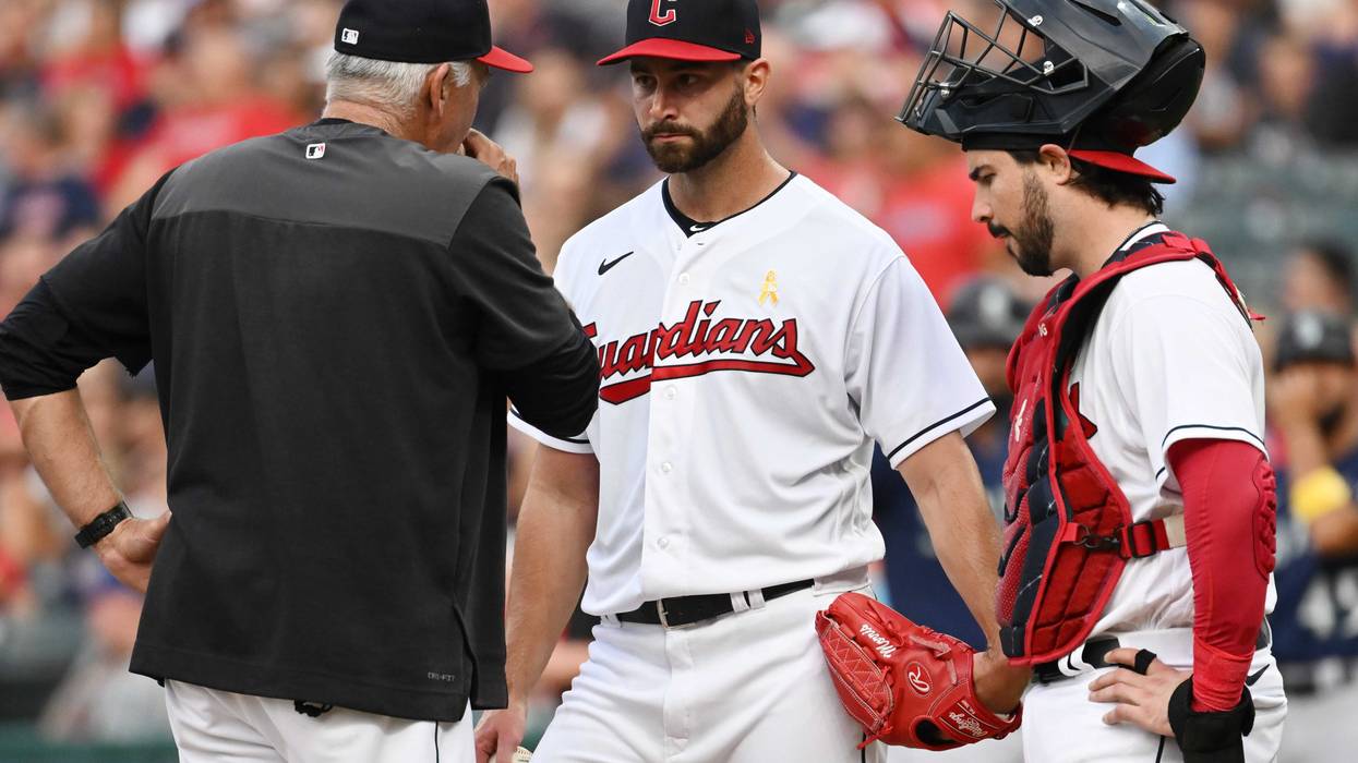 Cleveland Guardians pitching coach Carl Willis, left, talks to starting pitcher Cody Morris (36) and catcher Austin Hedges (17) during the first inning against the Seattle Mariners at Progressive Field.