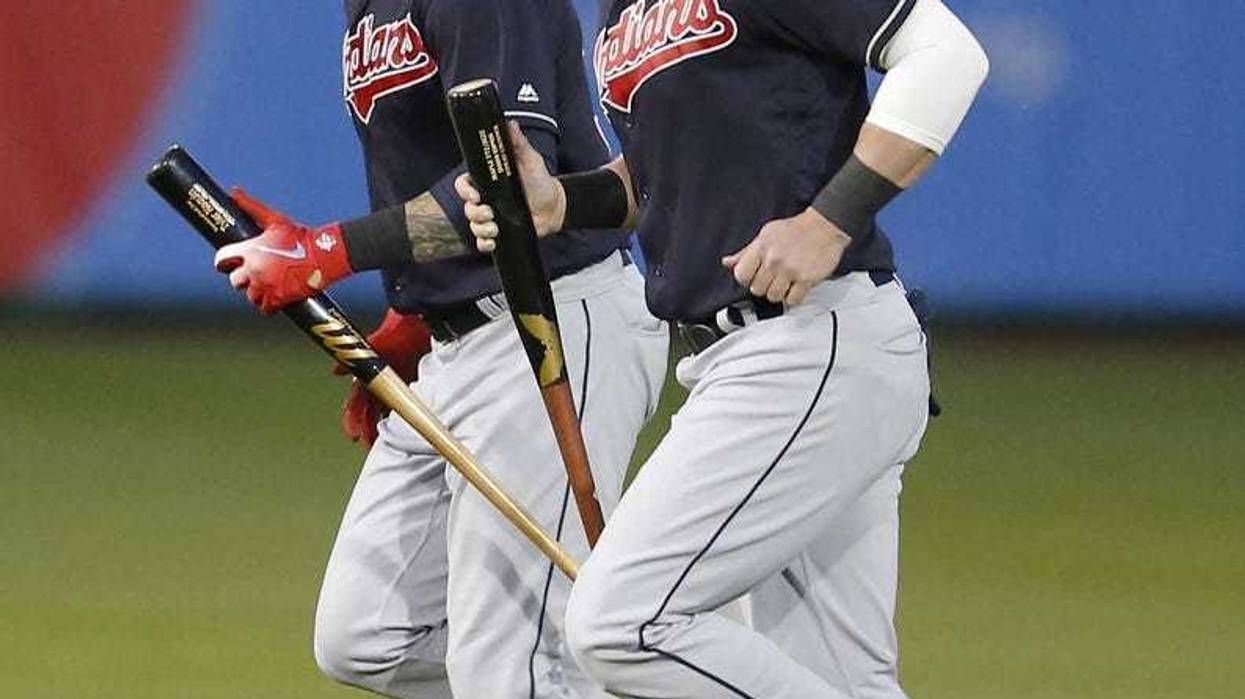 Cleveland Indians center fielder Tyler Naquin (30) and Jason Kipnis (22) warm up before a spring training game against the San Francisco Giants at Scottsdale Stadium.