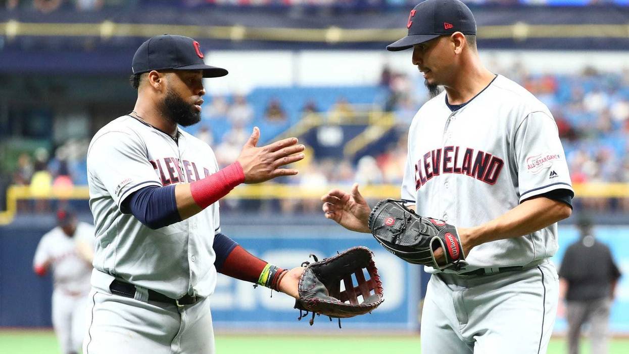 Cleveland Indians first baseman Carlos Santana (left) and pitcher Carlos Carrasco (right)
