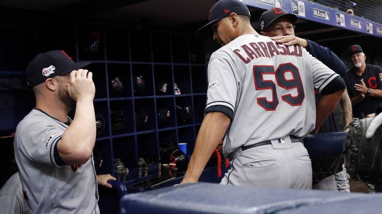 Cleveland Indians manager Terry Francona (77) hugs pitcher Carlos Carrasco (59) after he pitched the seventh inning for the first time since he was diagnosed with leukemia against the Tampa Bay Rays at Tropicana Field.