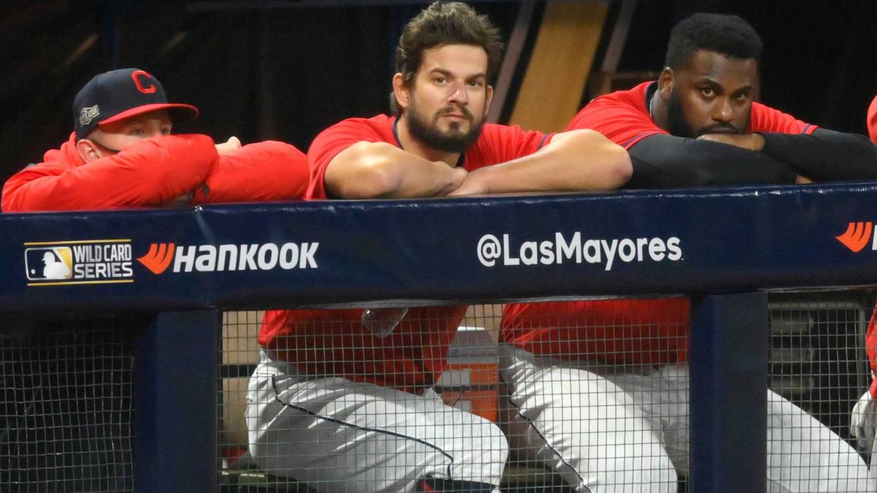 Cleveland Indians relief pitcher Brad Hand (33), center, watches from the dugout after blowing a save in the ninth inning against the New York Yankees at Progressive Field.