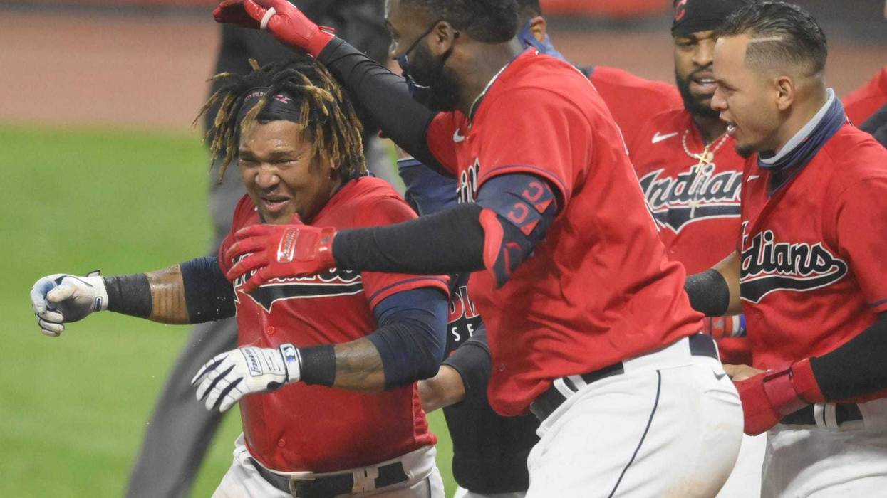 Cleveland Indians third baseman Jose Ramirez (11), left, celebrates his game-winning, three-run home run in the tenth inning against the Chicago White Sox at Progressive Field.