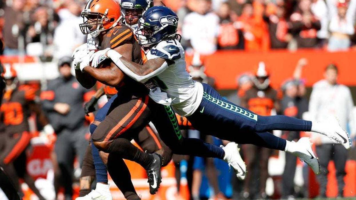 CLEVELAND, OH - OCTOBER 13: Shaquill Griffin #26 of the Seattle Seahawks and Tre Flowers #21 combine to tackle Nick Chubb #24 of the Cleveland Browns during the first quarter at FirstEnergy Stadium on October 13, 2019 in Cleveland, Ohio. (Photo by Kirk Ir