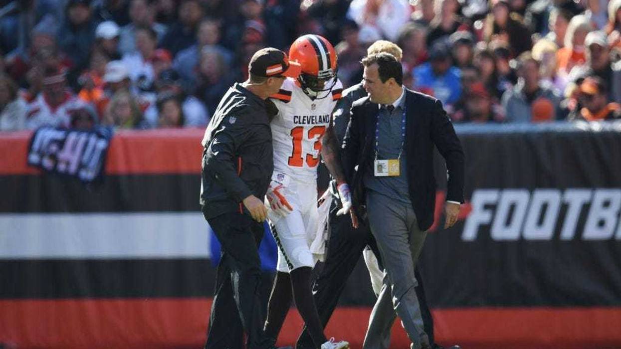 CLEVELAND, OH - OCTOBER 14: Rod Streater #13 of the Cleveland Browns is escorted offsides the field by medical staff in the first quarter against the Los Angeles Chargers at FirstEnergy Stadium on October 14, 2018 in Cleveland, Ohio.