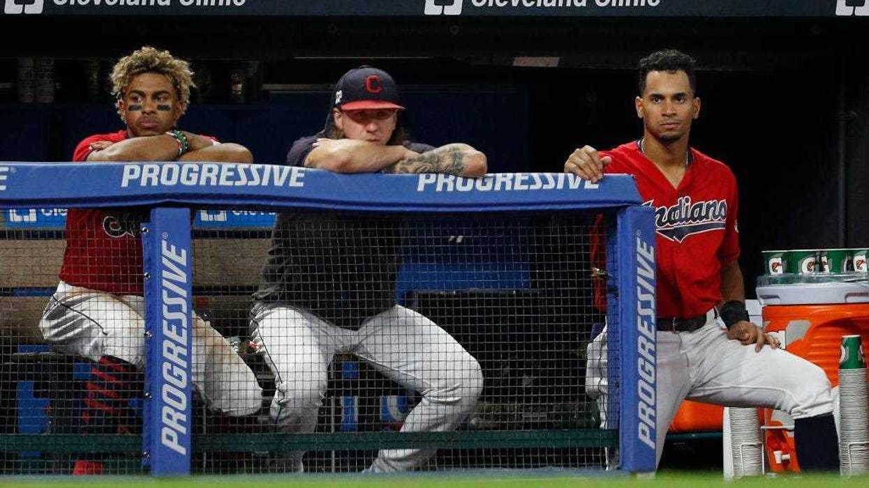 CLEVELAND, OH - SEPTEMBER 21: Francisco Lindor #12, Mike Clevinger #52 and Oscar Mercado #35 of the Cleveland Indians watch from the dugout during the sixth inning against the Philadelphia Phillies at Progressive Field on September 21, 2019 in Cleveland,