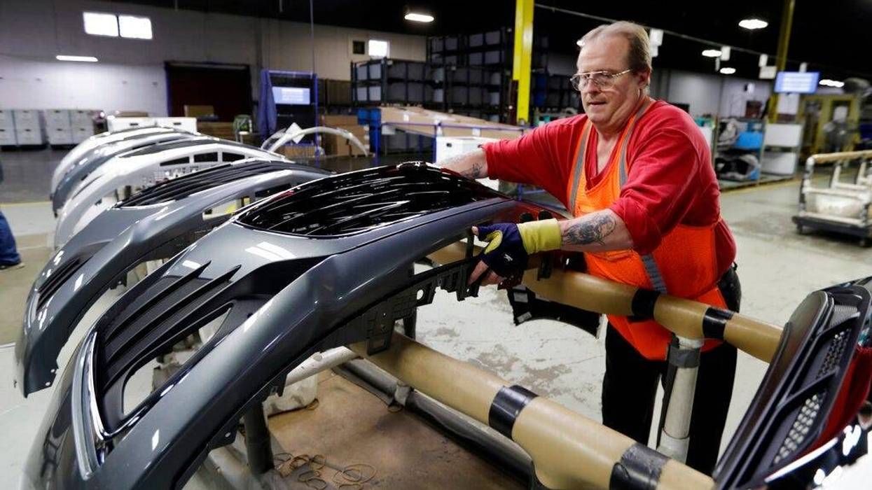 Clifford Goff, a bezel assembler, transferring a front end of a General Motors Chevrolet Cruze during assembly at Jamestown Industries, in Youngstown, Ohio.