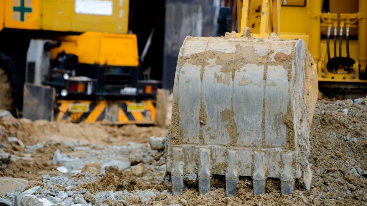 Close call as excavator flips during demolition in Wilkes-Barre