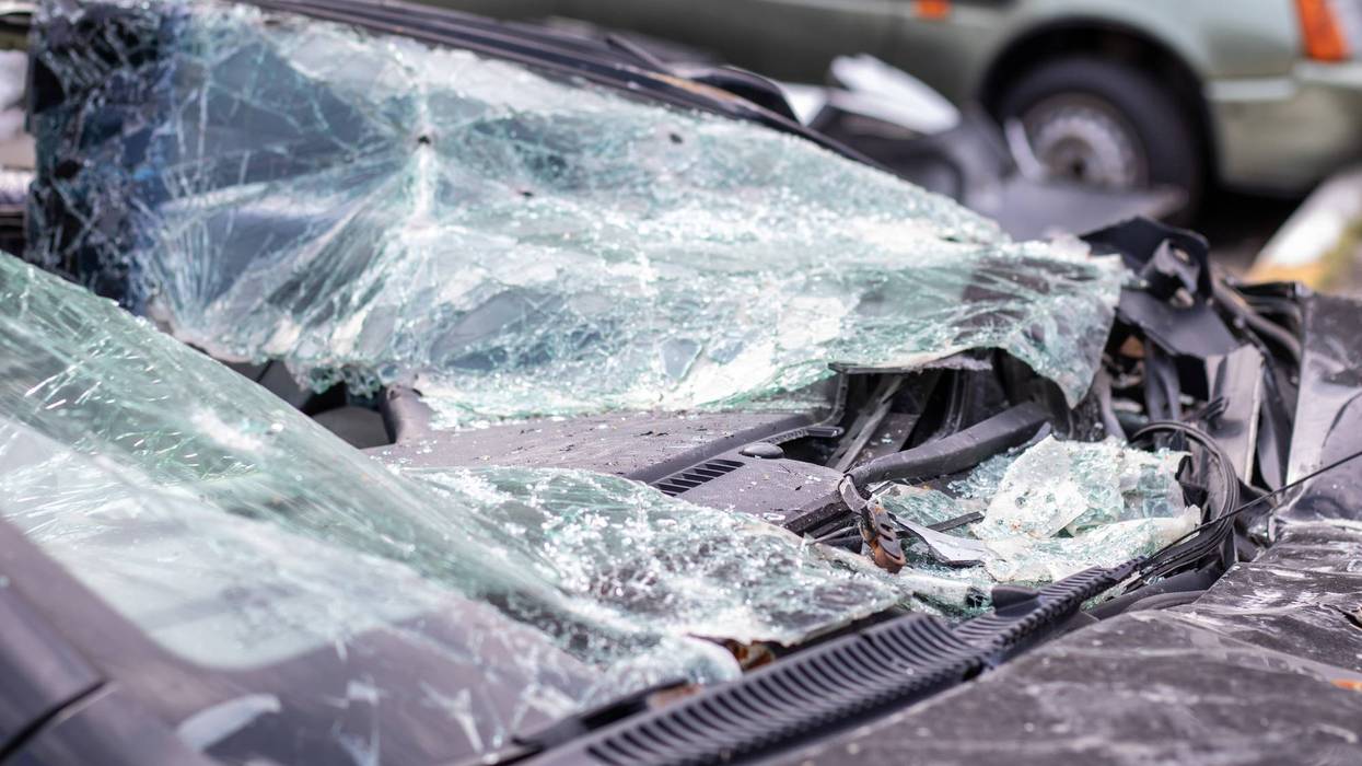 Close-up of a car with a broken windshield after a fatal crash. Consequence of a fatal car accident. Automobile danger. Reckless dangerous driving. Vehicle after an accident with a pedestrian.
