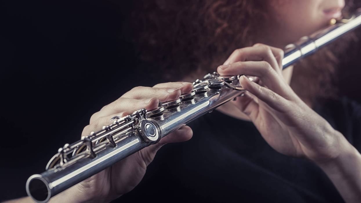 Close-up of a woman playing the flute.