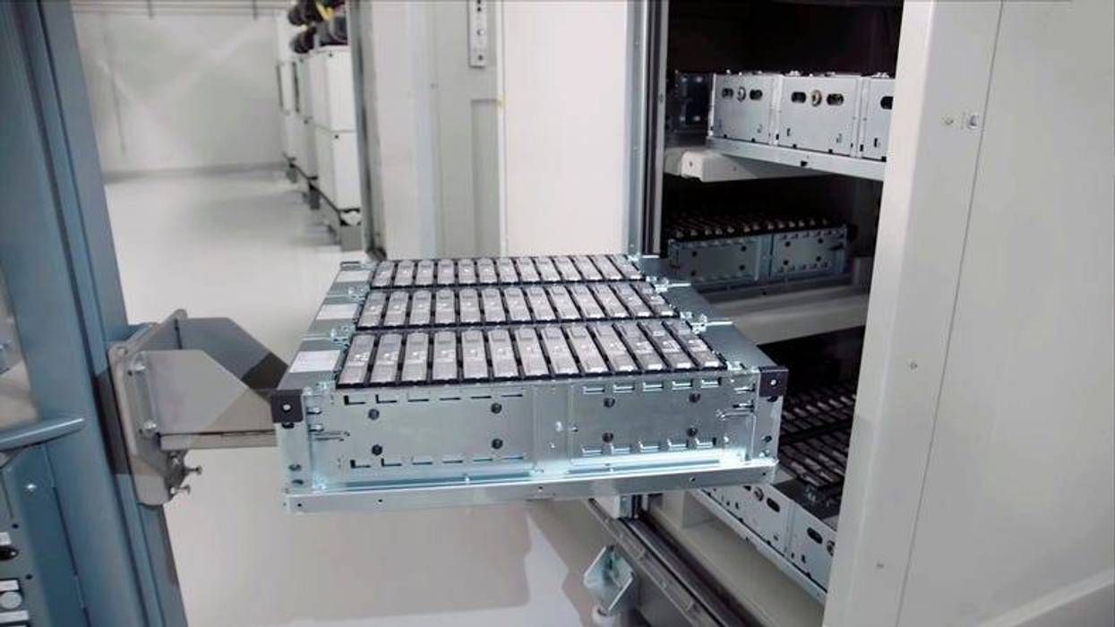 close-up of an electric car battery on top of a forklift truck going into a cabinet in an electric car battery factory.