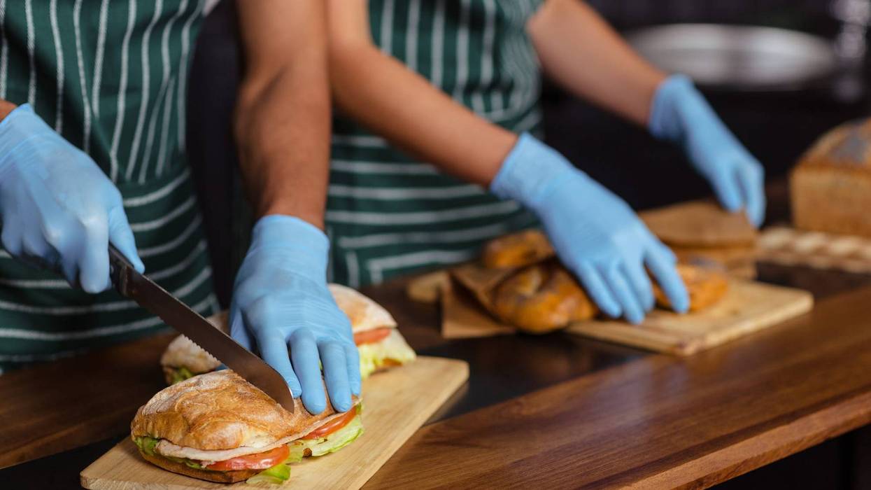 Close up of baristas preparing sandwiches in the bar