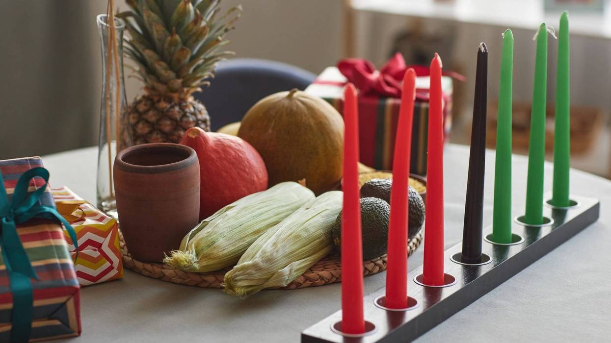 Close-up of seven candles with exotic fruits on table preparing for Kwanzaa holiday