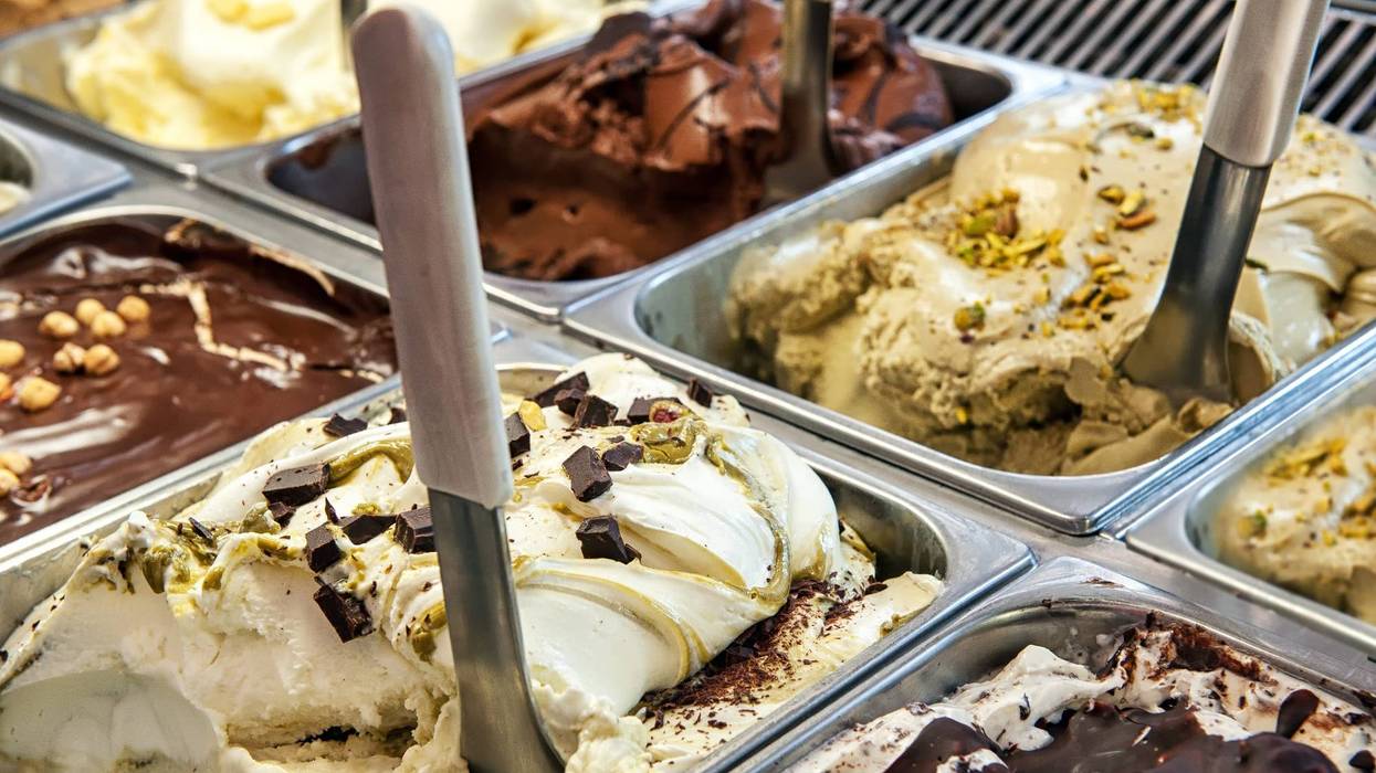 Close up of trays of different ice cream in assorted flavors.