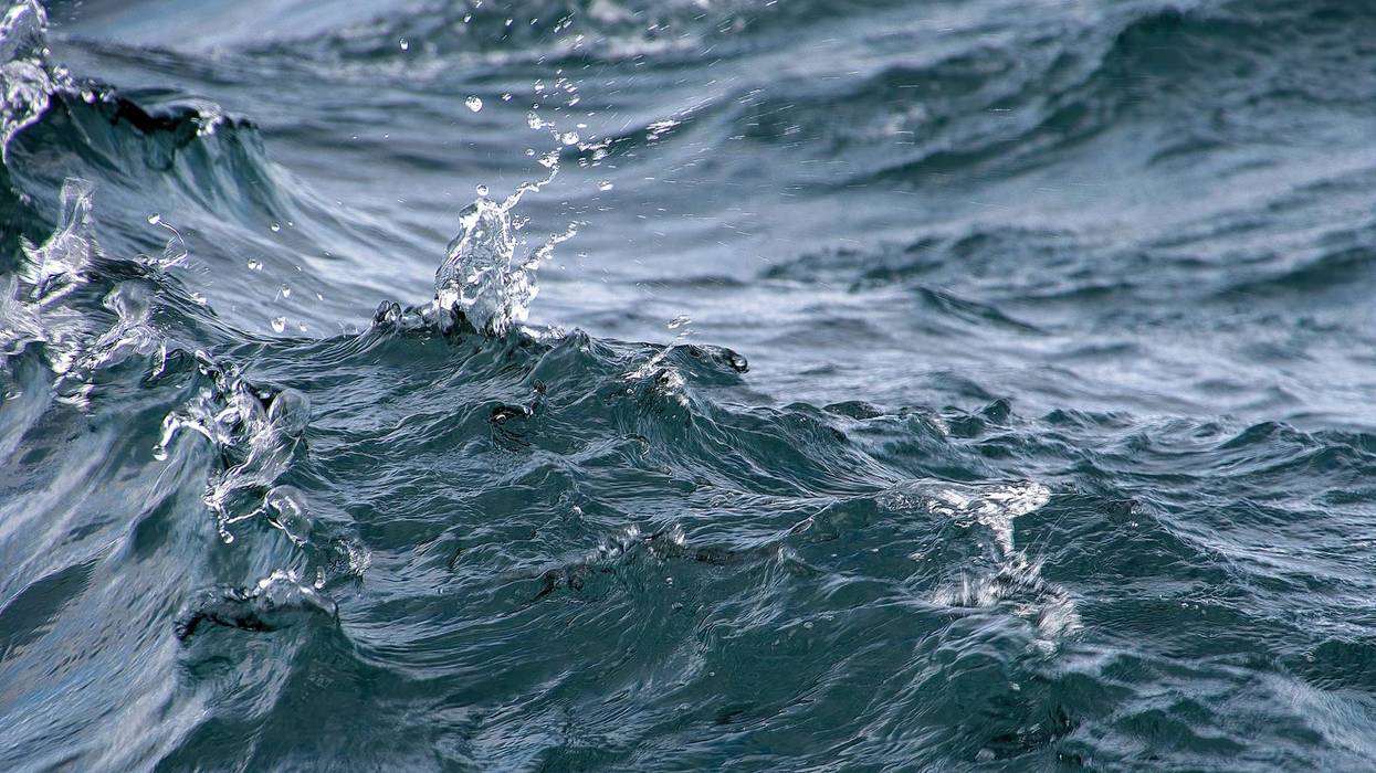 Close up of wavy lake water with splash droplets