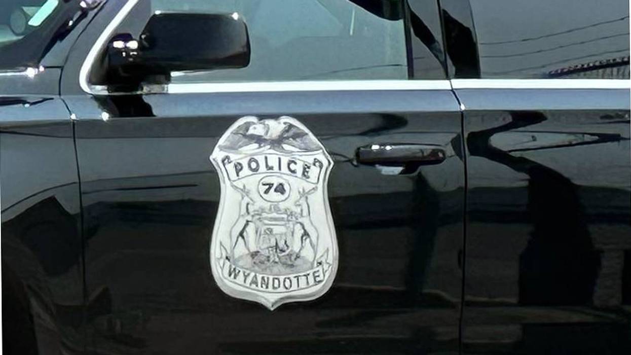 Close-up of Wyandotte Police badge on a black patrol car door.