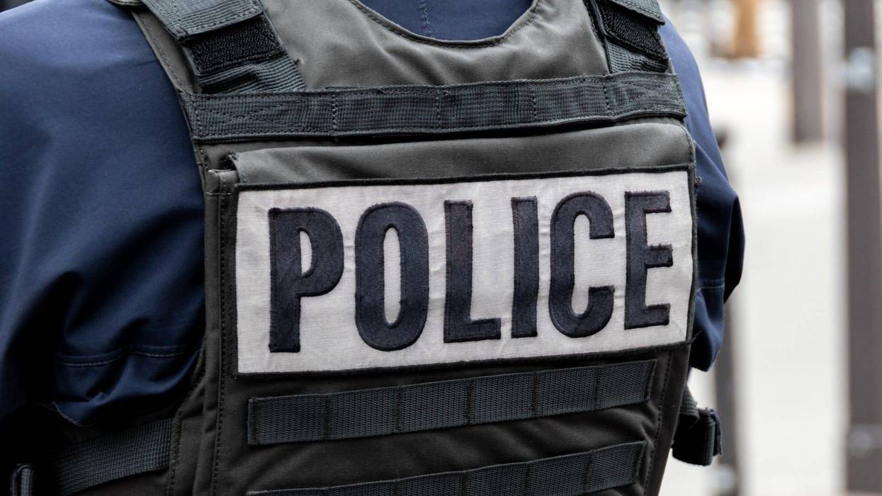 Close-up 'POLICE' marking written on the back of a bulletproof vest