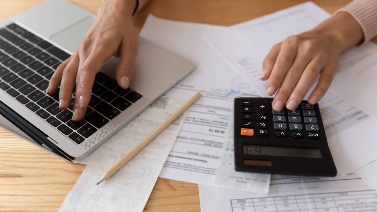 Close up young woman using computer software application, checking financial data, calculating domestic household expenditures, managing budget, planning investment or paying taxes bills online.