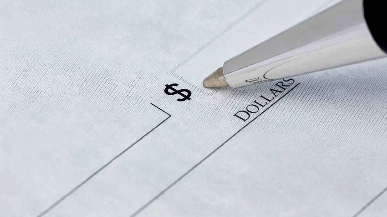 Closeup of a pen writing on a check