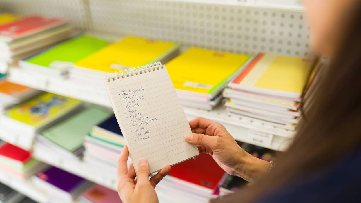 Closeup of a woman holding school supply list shopping stationery