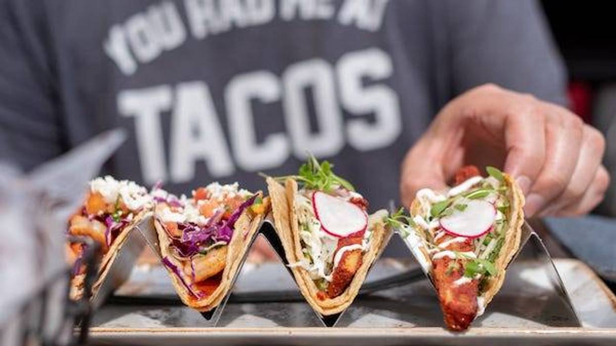 Closeup of man eating tacos