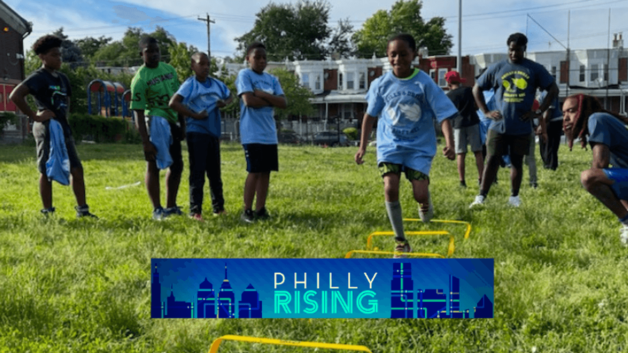 Coaches and volunteers run kids through drills at a youth program in West Philadelphia.