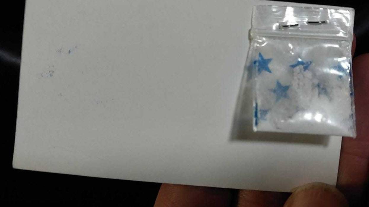 Cocaine stapled to a business card.