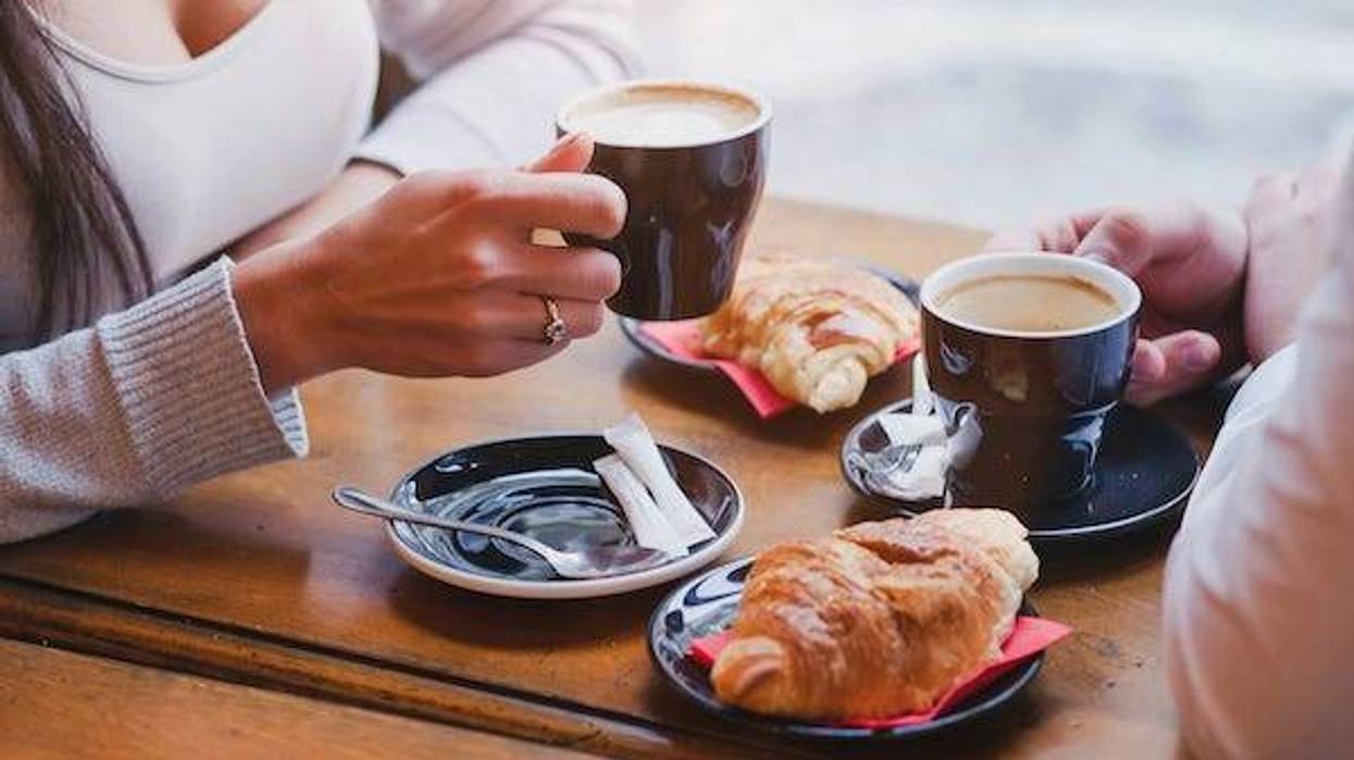Coffee and croissants in cafe, couple having breakfast