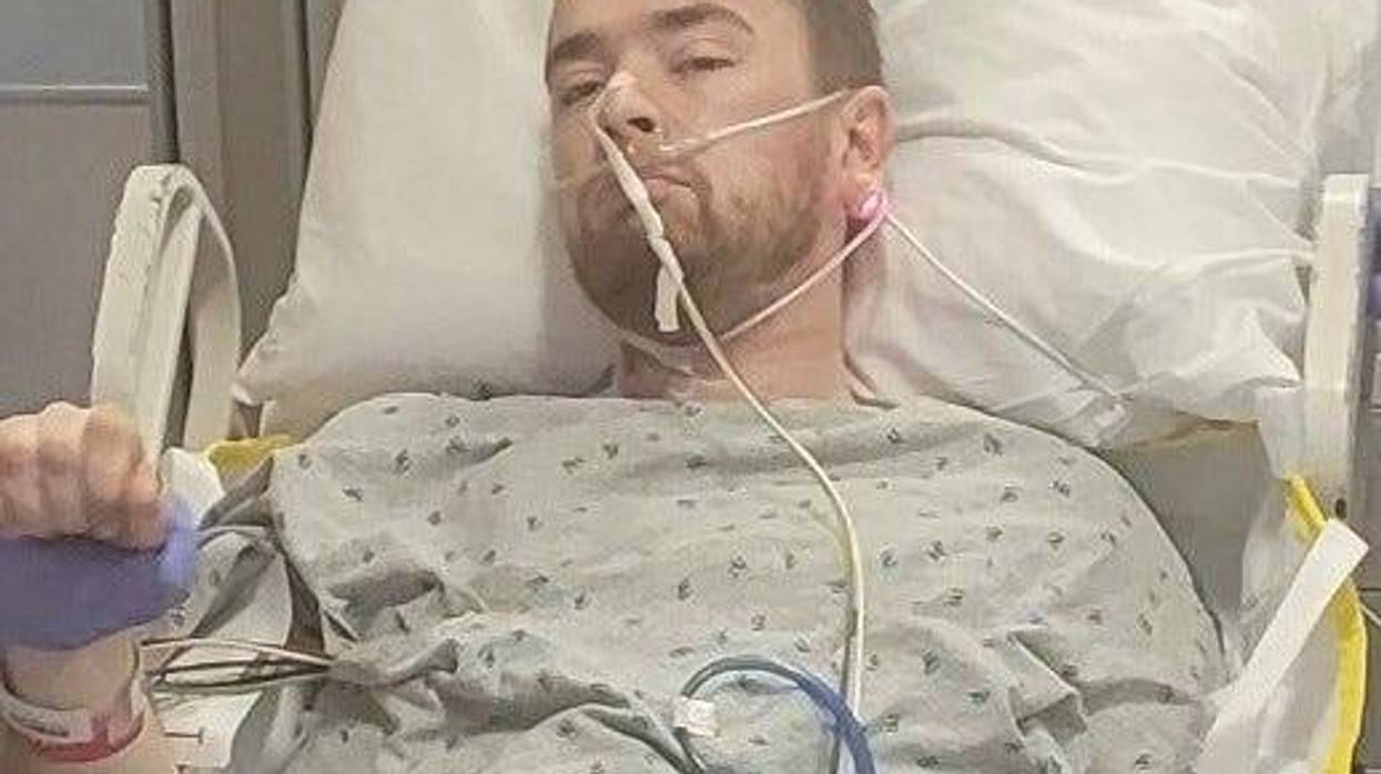 Colin Ledbetter is in a hospital gown hooked up to an IV