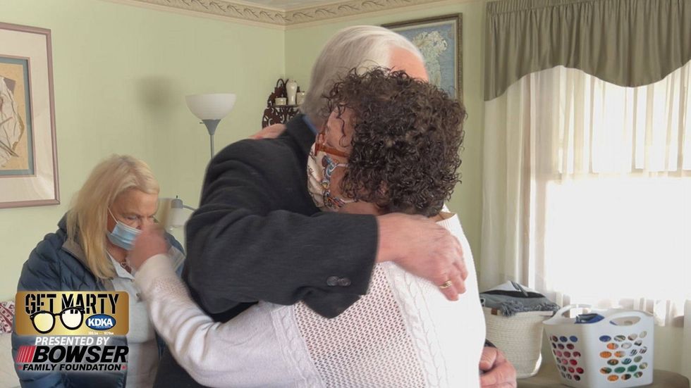 Colleen hugs Dale Kleiner after receiving a gift of $10,000.