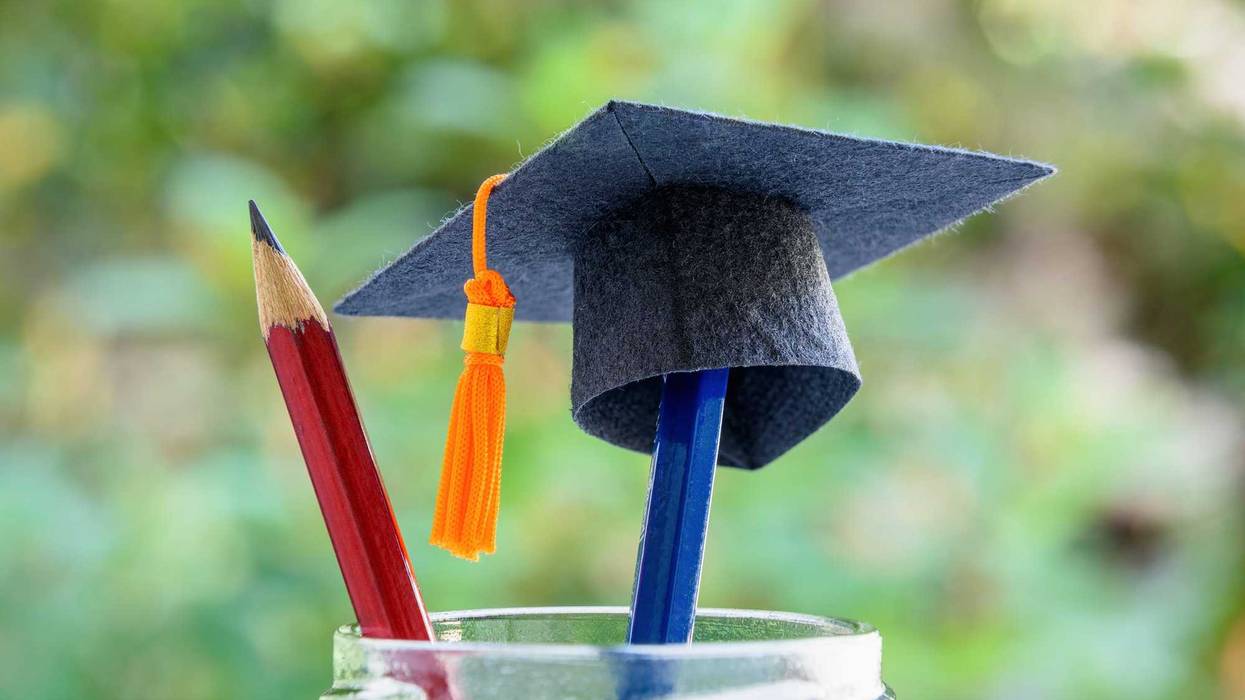 College cap on two pencils.