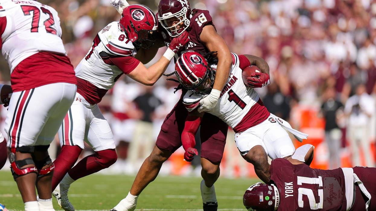 COLLEGE STATION, TEXAS - NOVEMBER 15: Rahsul Faison #1 of the South Carolina Gamecocks carries as he is tackled by T.J. Searcy #18 of the Texas A&M Aggies during the second quarter at Kyle Field on November 15, 2025 in College Station, Texas. (Photo by Alex Slitz/Getty Images) \sc