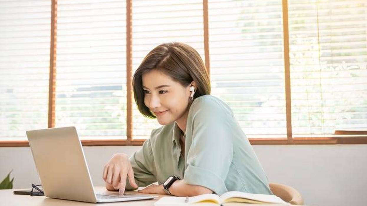 college student with airpods and laptop