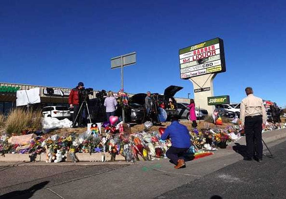 COLORADO SPRINGS, COLORADO - NOVEMBER 21: People visit a makeshift memorial near the Club Q nightclub on November 21, 2022 in Colorado Springs, Colorado